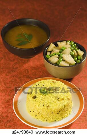 Stock Image - Close-up of rice in a plate with lentils and pees with potato slices. Fotosearch