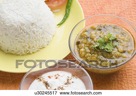 Close-up of rice in a plate with chickpea curry and rayta View Large Photo Image Stock Photo - Close-up of rice in a plate with chickpea curry and rayta. Fotosearch