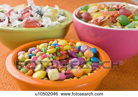 Stock Photograph - Close-up of three bowls full of candies. Fotosearch