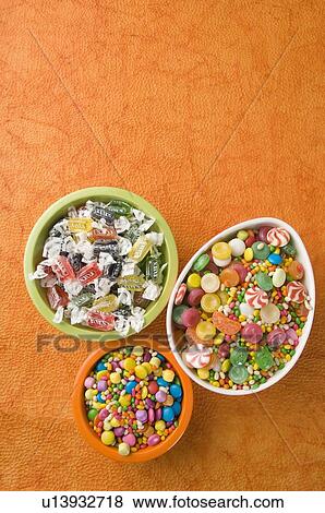 Stock Photo - High angle view of three bowls full of candies. Fotosearch