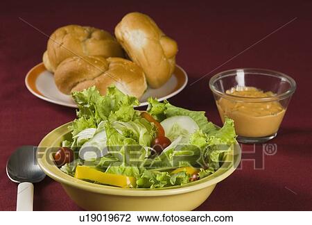 Close-up of a bowl of salad and a plate of buns View Large Photo Image Stock Image - Close-up of a bowl of salad and a plate of buns. Fotosearch