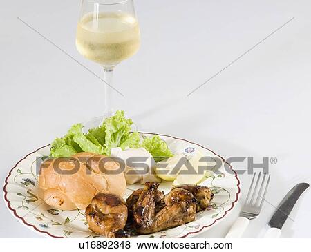 Close-up of roasted chicken and bun in a plate with a glass of wine View Large Photo Image Stock Photo - Close-up of roasted chicken and bun in a plate with a glass of wine. Fotosearch