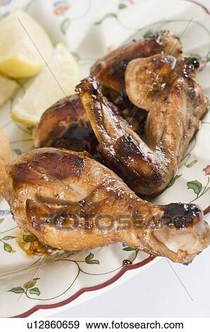 Stock Photo - Close-up of roasted chicken in a plate. Fotosearch