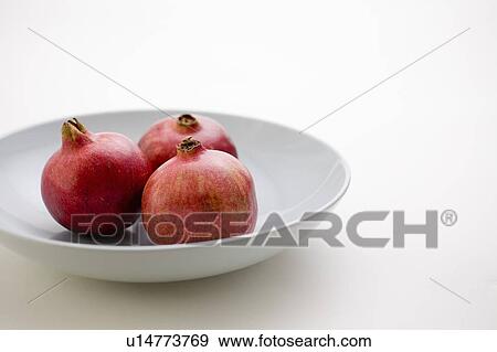 3 Pomegranates in low bowl View Large Photo Image Stock Photo - 3 Pomegranates in low bowl. Fotosearch