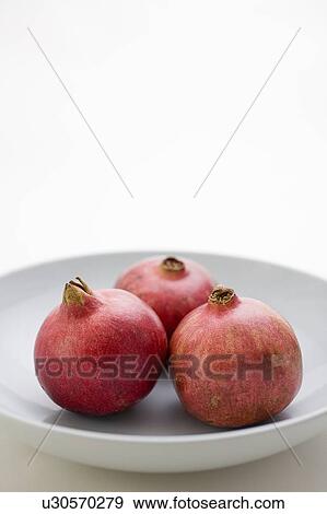 3 Pomegranates in low bowl View Large Photo Image Stock Photo - 3 Pomegranates in low bowl. Fotosearch