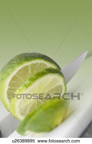 Stock Photography - A knife cutting a lime. Fotosearch