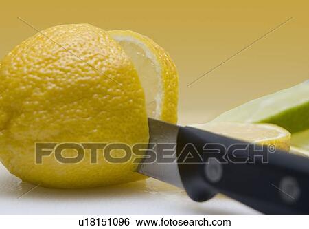 Stock Photograph - Knife slicing organic lemons . Fotosearch