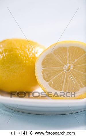 lemon and half lemon on plate View Large Photo Image Stock Photo - lemon and half lemon on plate. Fotosearch