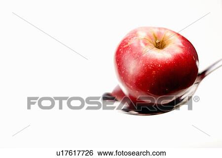 Stock Photograph - Organic apple in spoon. Fotosearch