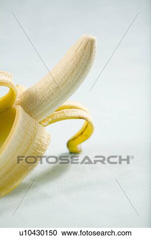 Partly peeled banana sitting up View Large Photo Image Stock Image - Partly peeled banana sitting up. Fotosearch