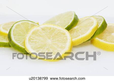 Stock Photo - slices of organic lemons and limes. Fotosearch