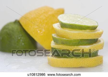 Stock Photograph - Stacked organic lemons and limes. Fotosearch