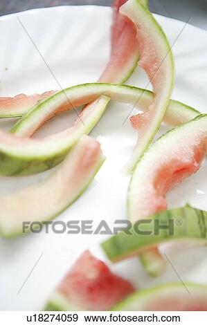 Stock Photo - Watermelon rinds on paper plate. Fotosearch