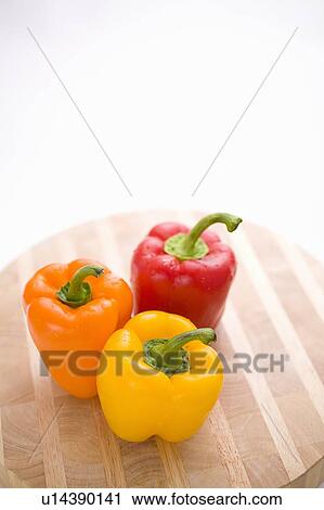 Stock Image - Yellow, orange and red peppers from above. Fotosearch
