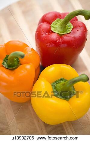 Stock Photograph - Yellow, orange and red peppers from above. Fotosearch