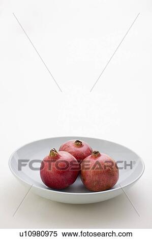 3 Pomegranates in low bowl View Large Photo Image Stock Photography - 3 Pomegranates in low bowl. Fotosearch