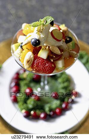 Stock Image - Festive fruit cocktail with mascarpone cheese in a martini glass. Fotosearch