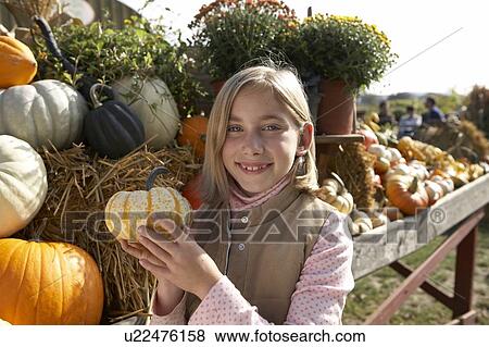 Girl holding organic squash, Ladner, British Columbia, Canada View Large Photo Image Stock Photo - Girl holding organic squash, Ladner, British Columbia, Canada. Fotosearch