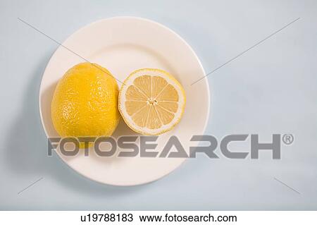 Stock Image - Lemons on white plate. Fotosearch
