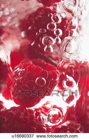 Stock Photo - Raspberries floating in water. Fotosearch