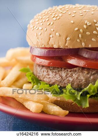 Beef Burger in a Sesame Seed Bun with Fries View Large Photo Image Stock Photograph - Beef Burger in a Sesame Seed Bun with Fries. Fotosearch