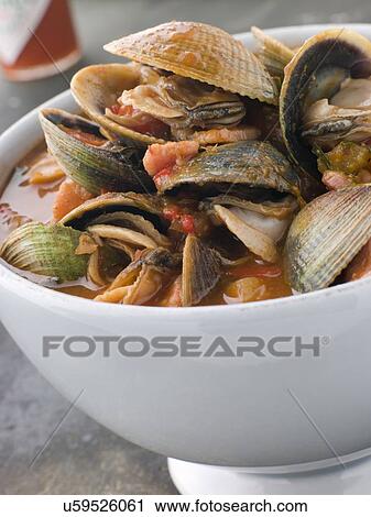Stock Image - Bowl of Manhattan Clams with Hot Chilli Sauce. Fotosearch