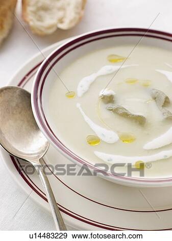 Stock Photo - Bowl of Vichyssoise with oil and Rustic Bread. Fotosearch