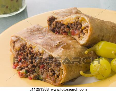 Chimichanga with Pickled Chillies and Guacamole View Large Photo Image Stock Image - Chimichanga with Pickled Chillies and Guacamole. Fotosearch