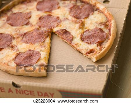 Picture - Pepperoni Pizza in a Take Away Box with a Slice Taken. Fotosearch