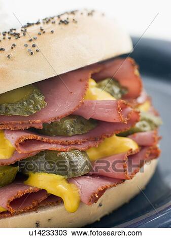 Poppy Seed Bagel with Pastrami Mustard and Gherkins View Large Photo Image Stock Image - Poppy Seed Bagel with Pastrami Mustard and Gherkins. Fotosearch