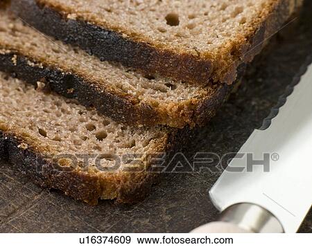 Stock Photo - Slices of Rye Bread on a Chopping Board. Fotosearch