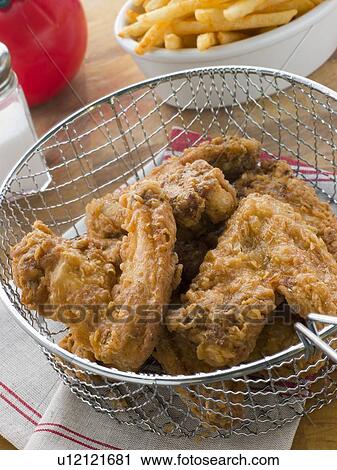 Stock Image - Southern Fried Chicken in a Basket with Fries. Fotosearch