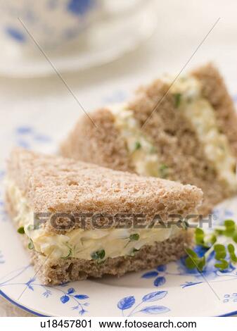 Stock Image - Egg and Cress Sandwich on Brown Bread with Afternoon Tea. Fotosearch