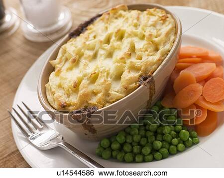 Individual Cottage Pie With Peas And Carrots Stock Photograph