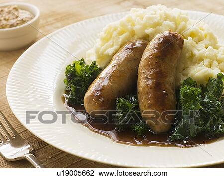 Stock Image - Pork Sausage and Mash with Curly Kale. Fotosearch