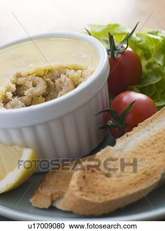 Stock Image - Potted Brown Shrimp with Toast and Salad. Fotosearch
