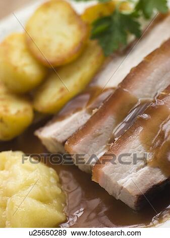 Roasted Belly Pork with Fried Potatoes and Apple Sauce View Large Photo Image Stock Photo - Roasted Belly Pork with Fried Potatoes and Apple Sauce. Fotosearch