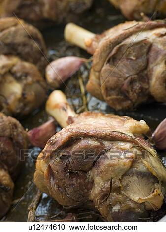 Stock Image - Slow Roasted Shanks of Spring Lamb. Fotosearch