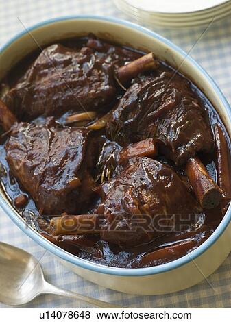 Spring Lamb Shanks braised in Red wine View Large Photo Image Stock Photo - Spring Lamb Shanks braised in Red wine. Fotosearch