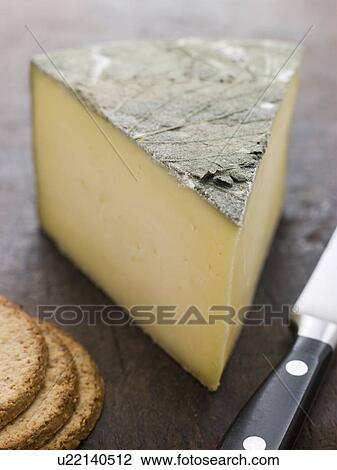 Stock Image - Wedge of Cornish Yarg Cheese with Oatmeal Biscuits. Fotosearch