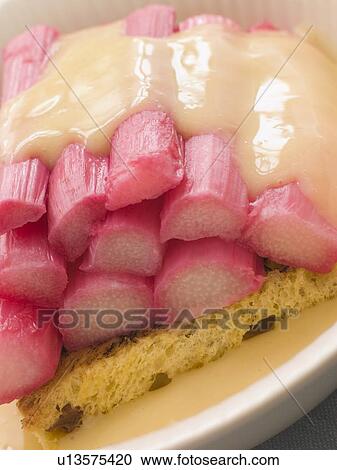 Stock Image - Bowl of Rhubarb and Custard with Saffron Cake. Fotosearch