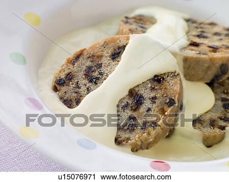 Stock Image - Bowl of Spotted Dick with Custard. Fotosearch