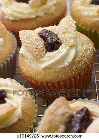 Stock Photograph - Butterfly Cup Cakes with Strawberry Jam. Fotosearch