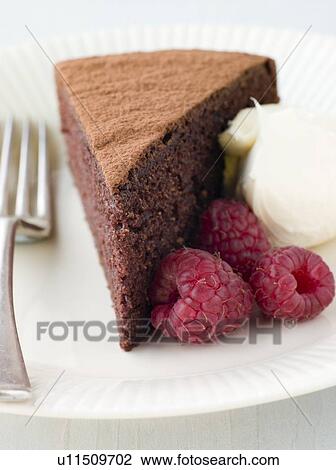 Stock Image - Chocolate Sponge with Whipped Cream and Raspberries. Fotosearch