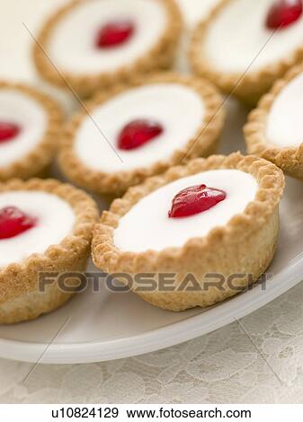 Plate of Cherry Bakewell Tarts View Large Photo Image Stock Photo - Plate of Cherry Bakewell Tarts. Fotosearch