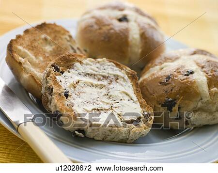 Stock Image - Plate of Toasted Hot Cross Buns with Butter. Fotosearch