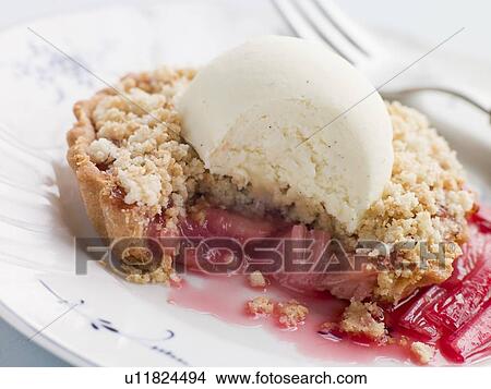 Picture - Rhubarb Crumble Tart with Vanilla Ice Cream. Fotosearch