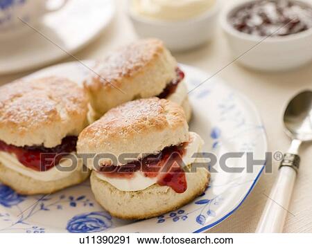 Stock Image - Scones Tea Clotted Cream and Jam. Fotosearch
