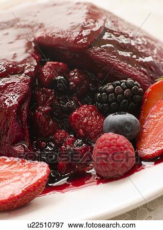 Traditional Summer Pudding with a scoop out View Large Photo Image Stock Photo - Traditional Summer Pudding with a scoop out. Fotosearch