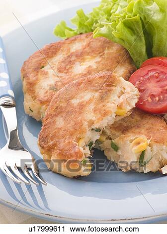 Stock Image - Cod and Salmon Fish Cakes with Corn and Salad. Fotosearch